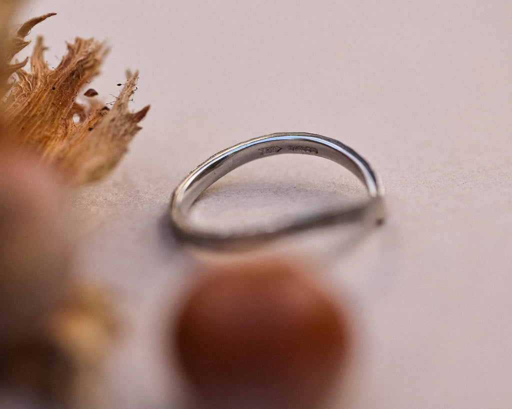 Back view of platinum wishbone ring with organic horn texture