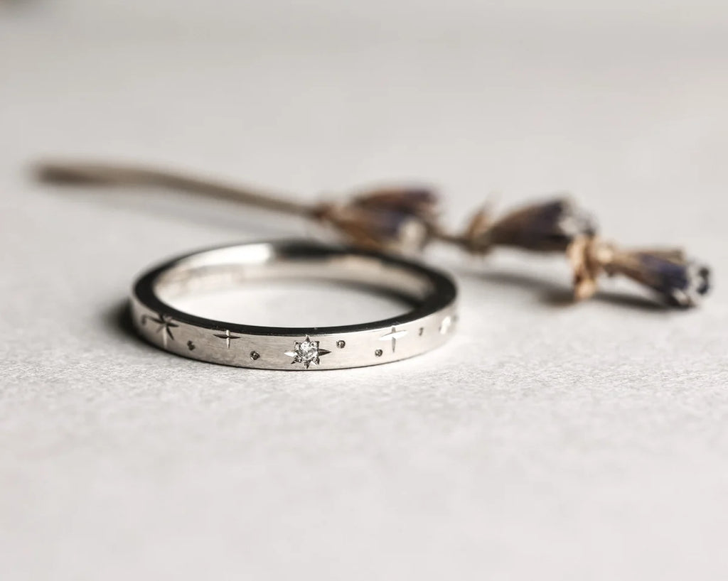 engraved star detail platinum band wedding ring