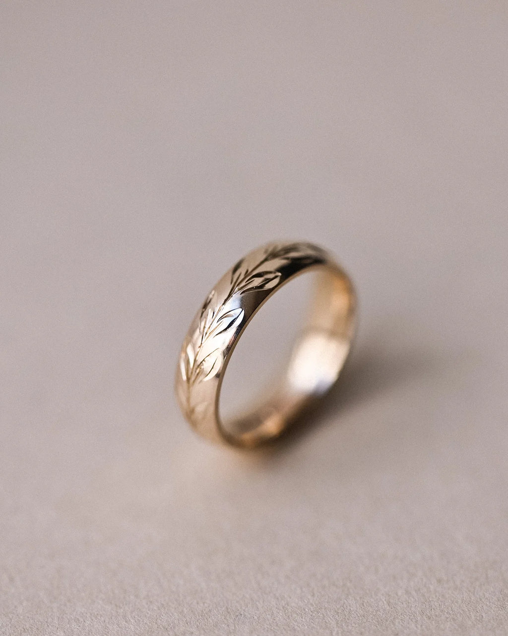 Side view of 9ct yellow gold olive leaf engraved wedding ring