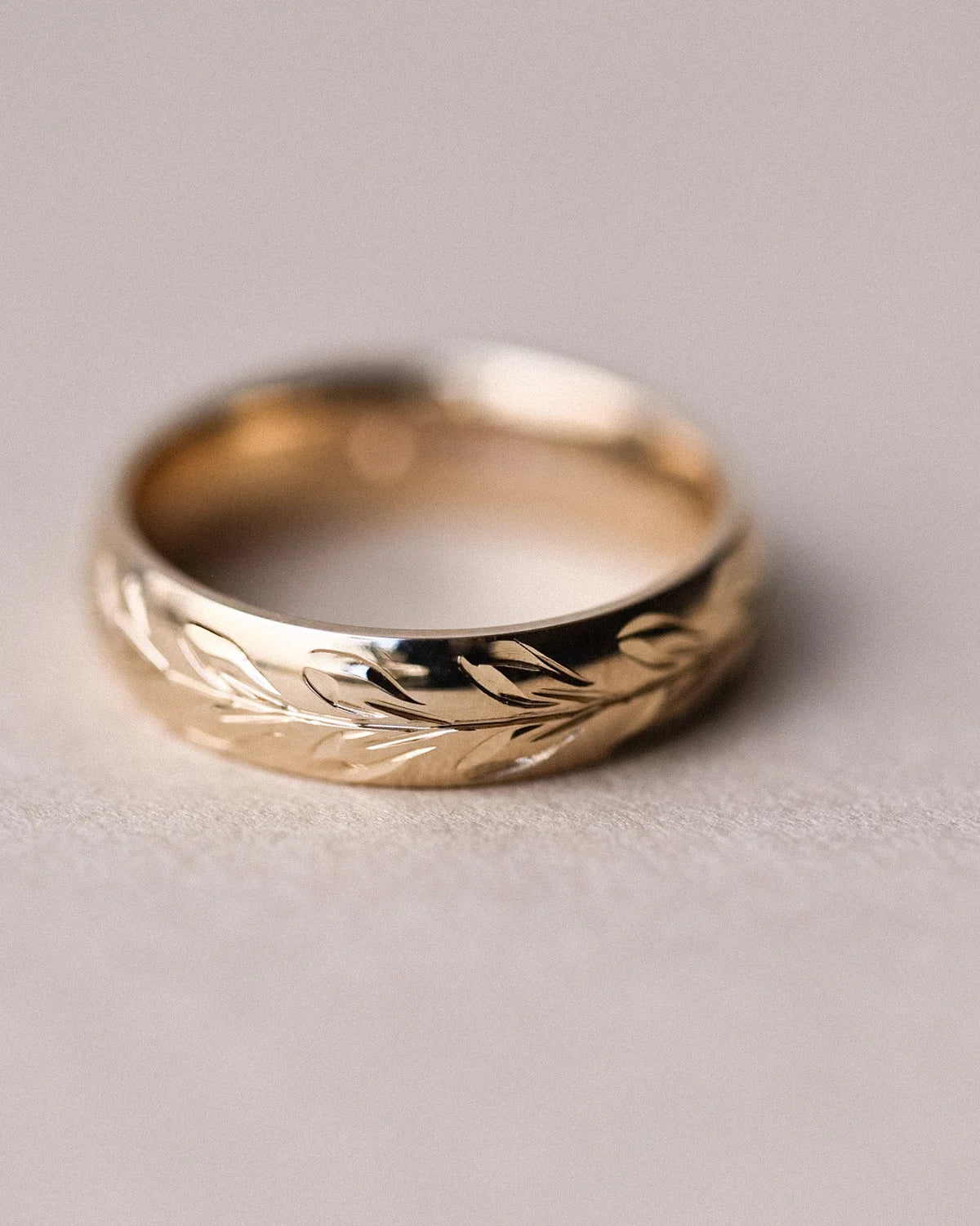 Detailed view of olive leaf engraving on 9ct yellow gold court ring
