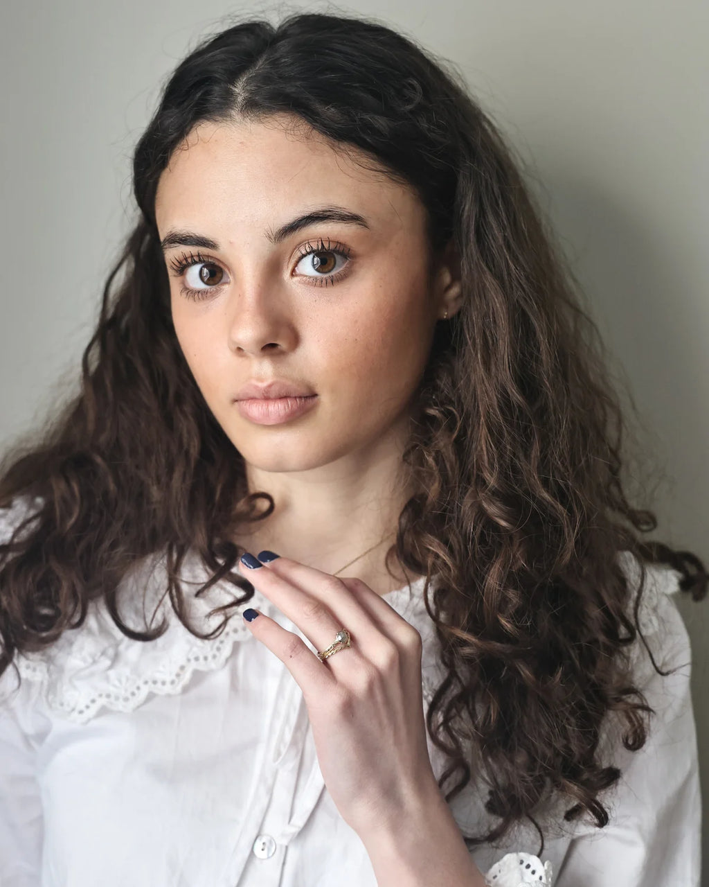 Editorial portrait wearing pale grey rose-cut diamond ring