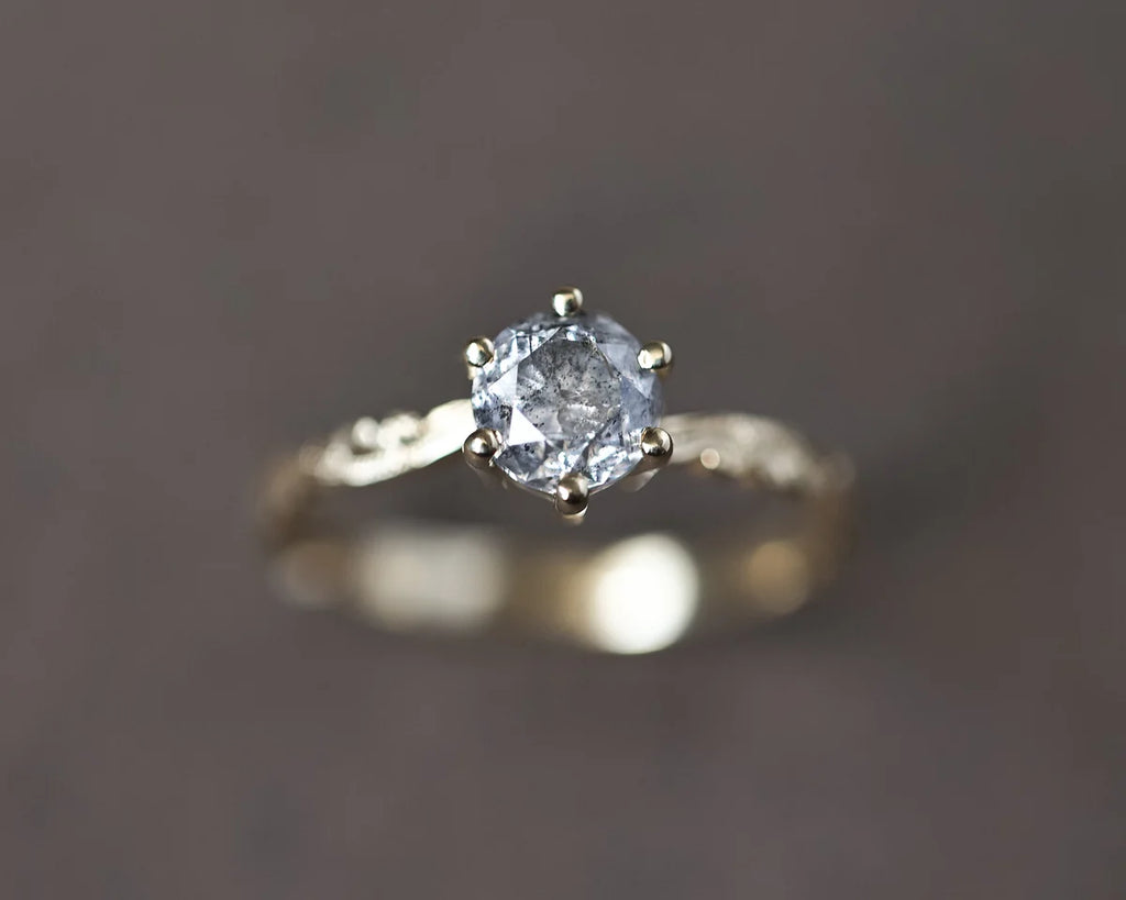 Angled view of 18ct yellow gold salt and pepper diamond ring