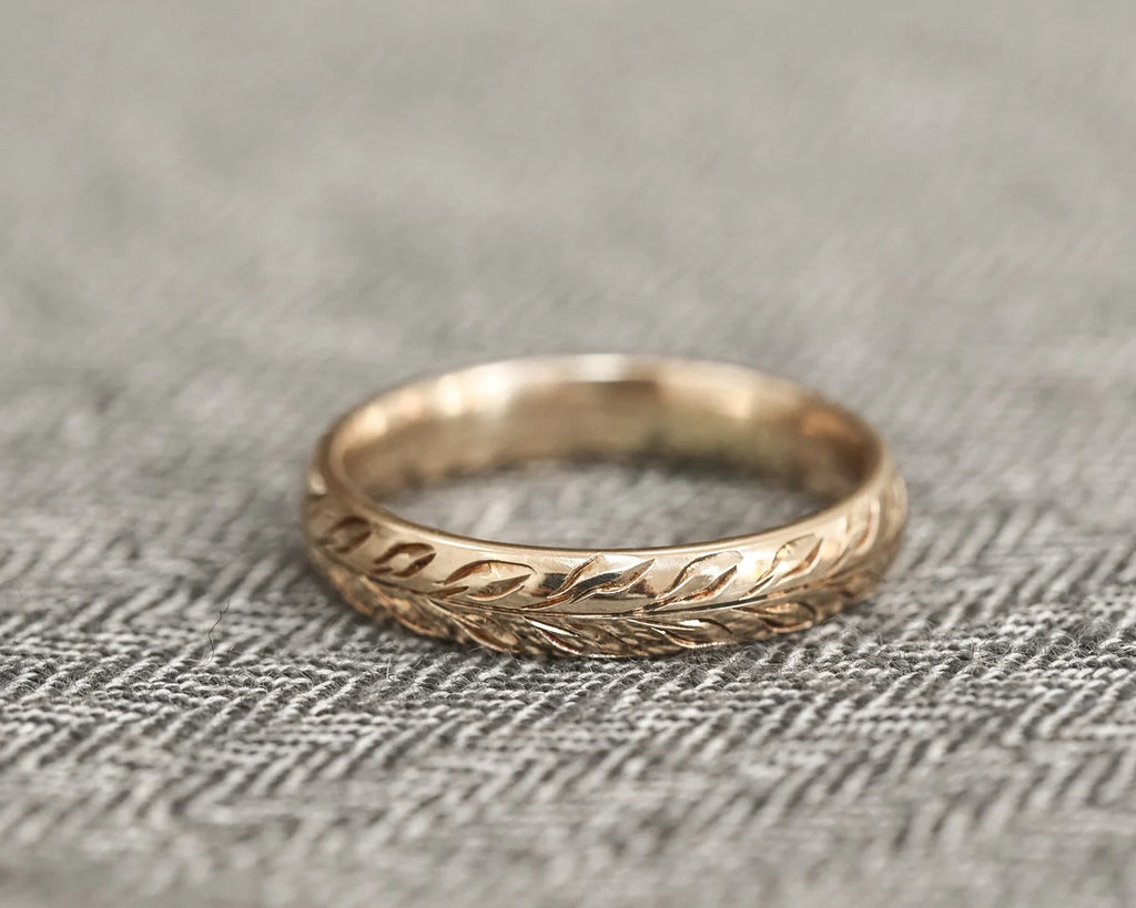 Low front view of 4mm olive leaf engraved wedding ring in yellow gold
