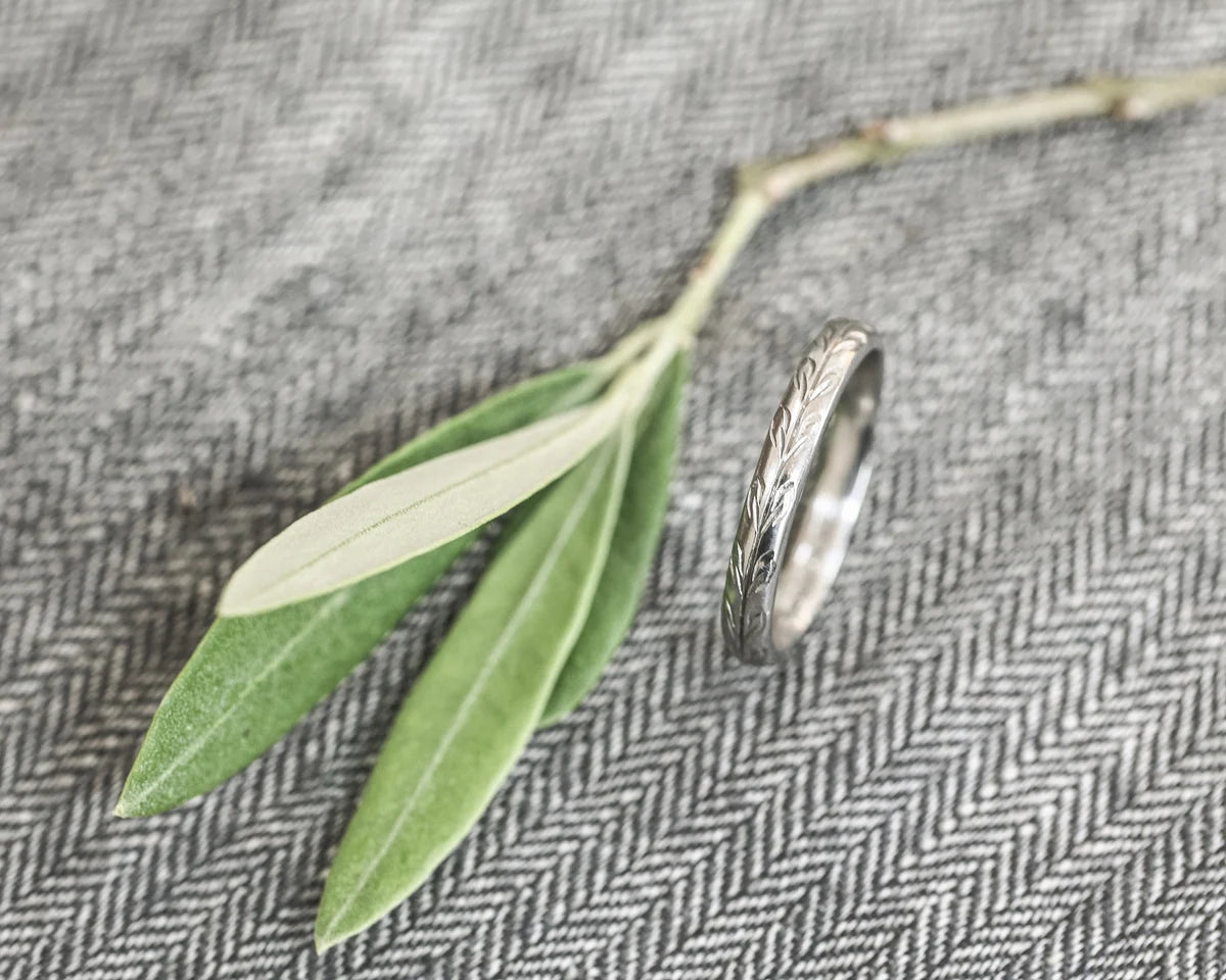 engraved olive pattern detail platinum band smooth finish ring

