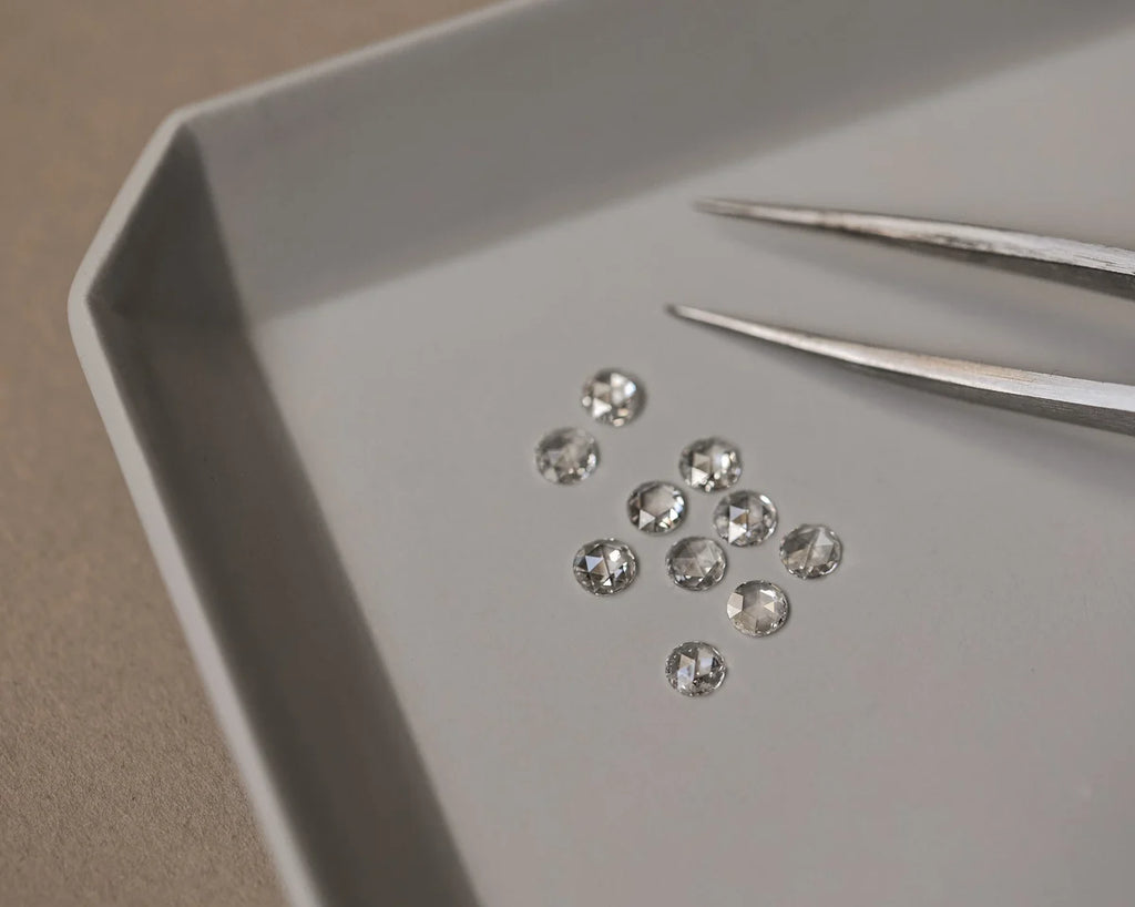 Diamonds on a tray with tweezers