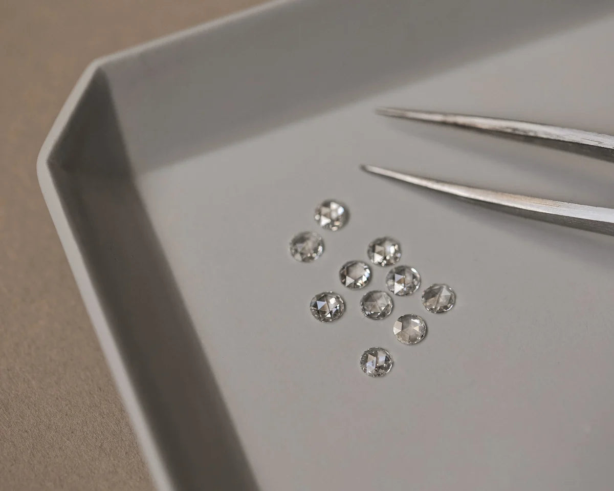 Diamonds on a tray with tweezers