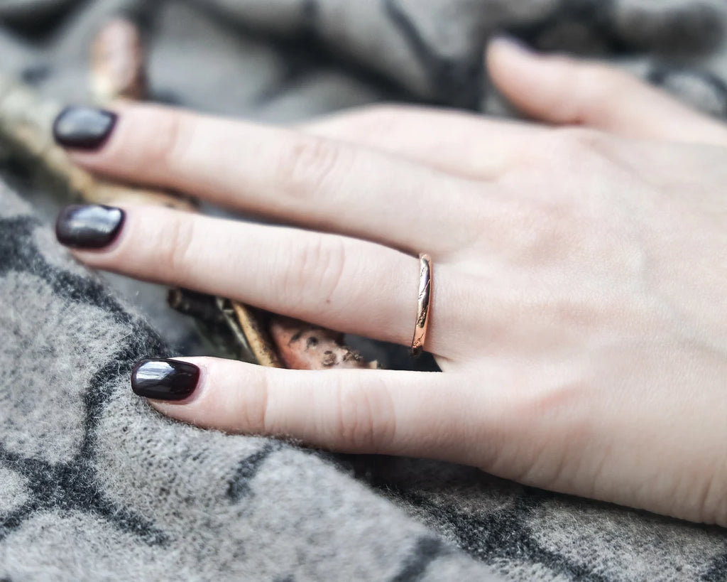 rose gold wedding ring worn on hand 18ct engraved band