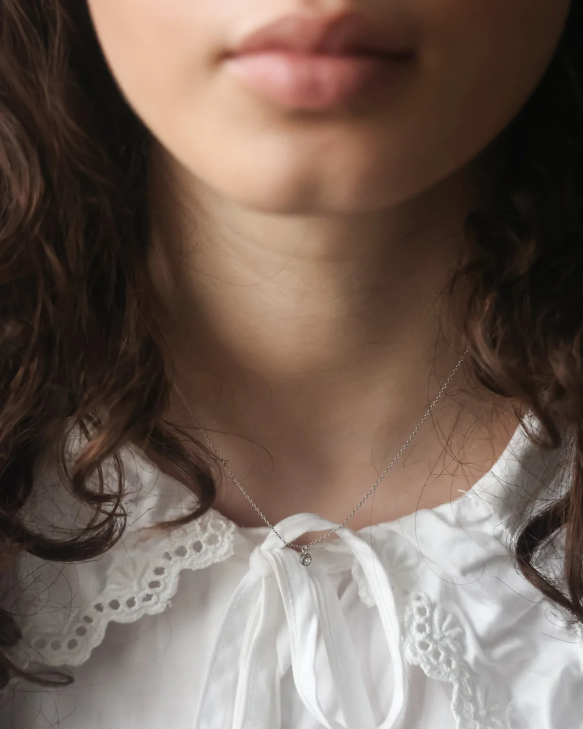 delicate platinum diamond necklace worn everyday