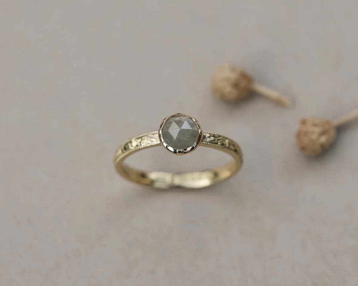 Angled view of 18ct yellow gold pale grey diamond ring