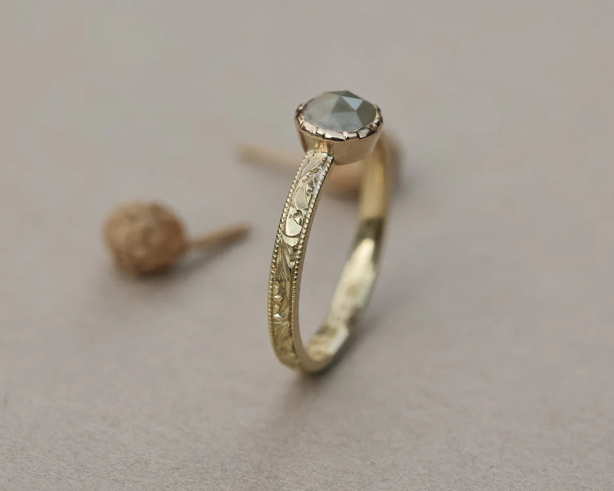 Vertical view of pale grey rose-cut diamond ring in yellow gold