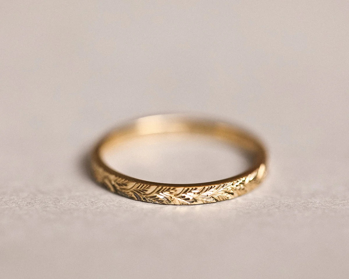 Front view of 2mm laurel leaf engraved wedding ring in yellow gold