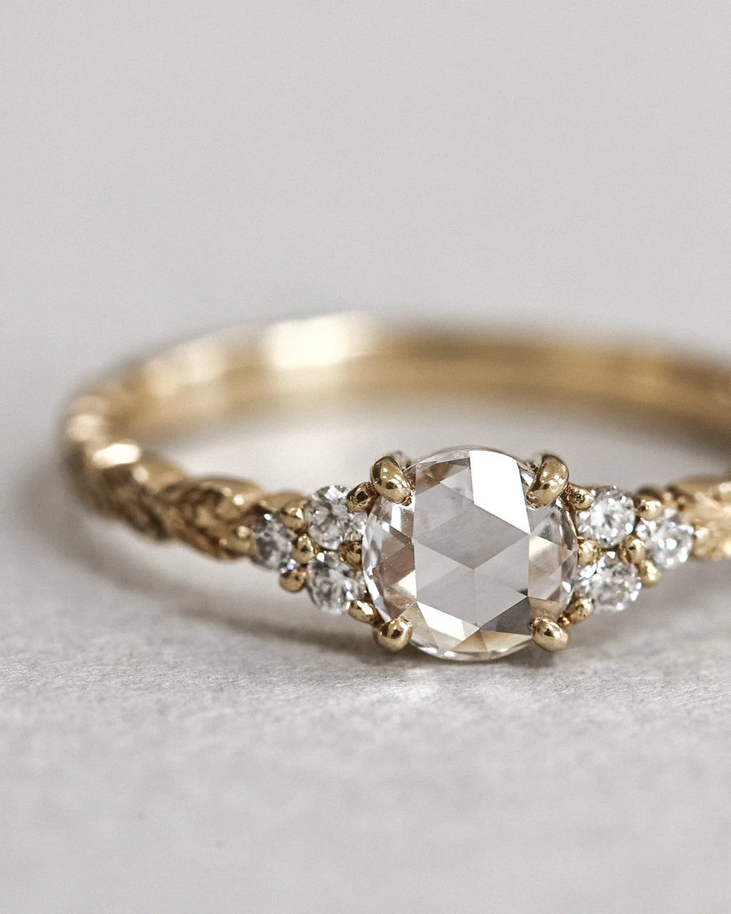 Angled view of 18ct yellow gold rose-cut diamond laurel ring