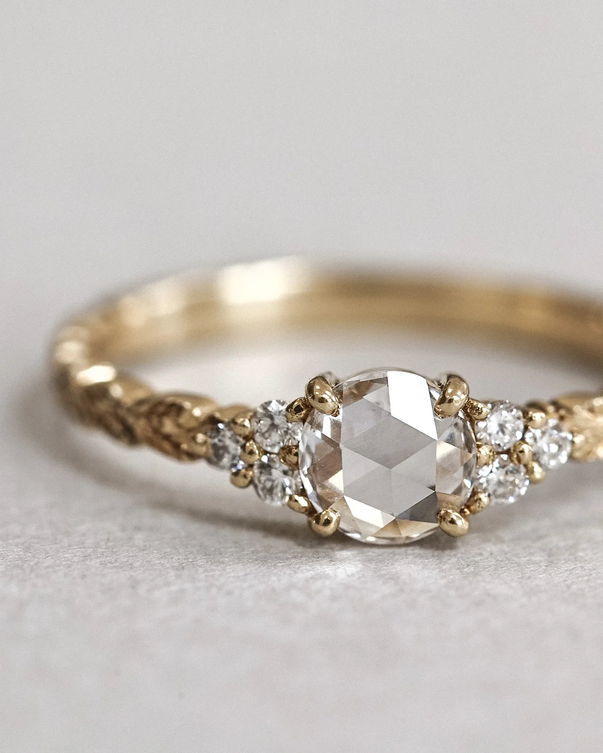 Angled view of 18ct yellow gold rose-cut diamond laurel ring