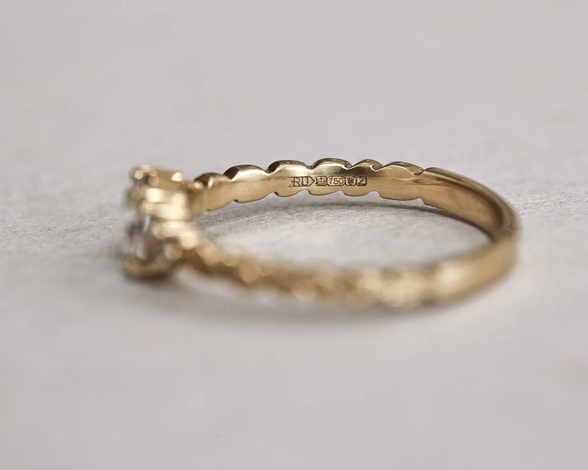 Side profile of hand carved laurel leaf diamond ring