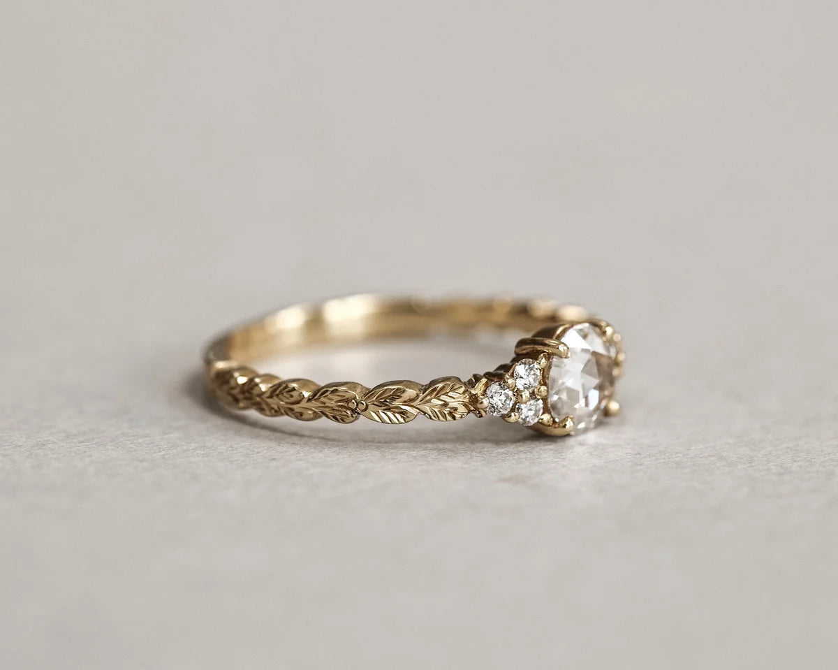 Side view of handmade laurel leaf diamond ring in yellow gold