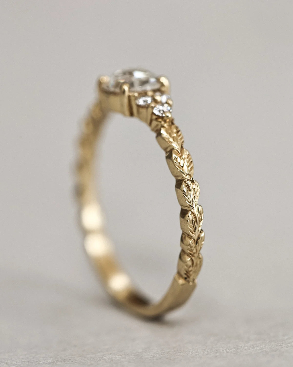 Vertical side view of 18ct yellow gold laurel leaf ring