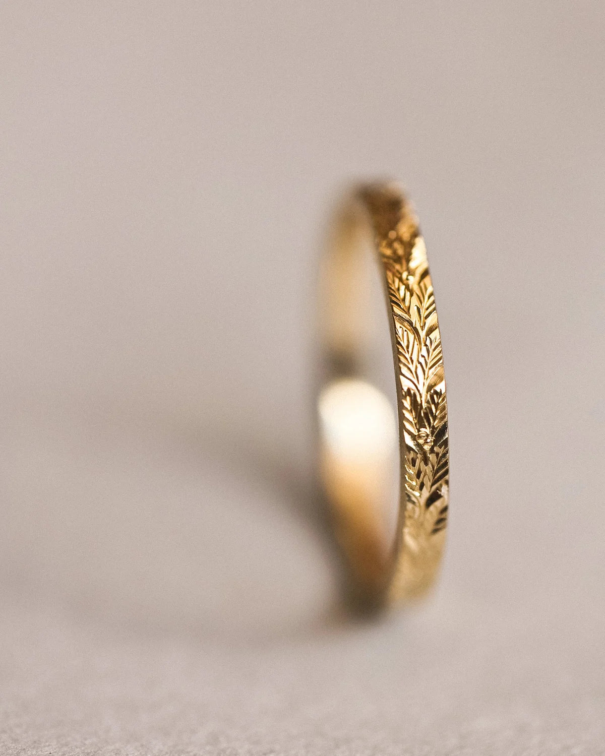 Vertical side view of handmade laurel leaf ring in 18ct yellow gold