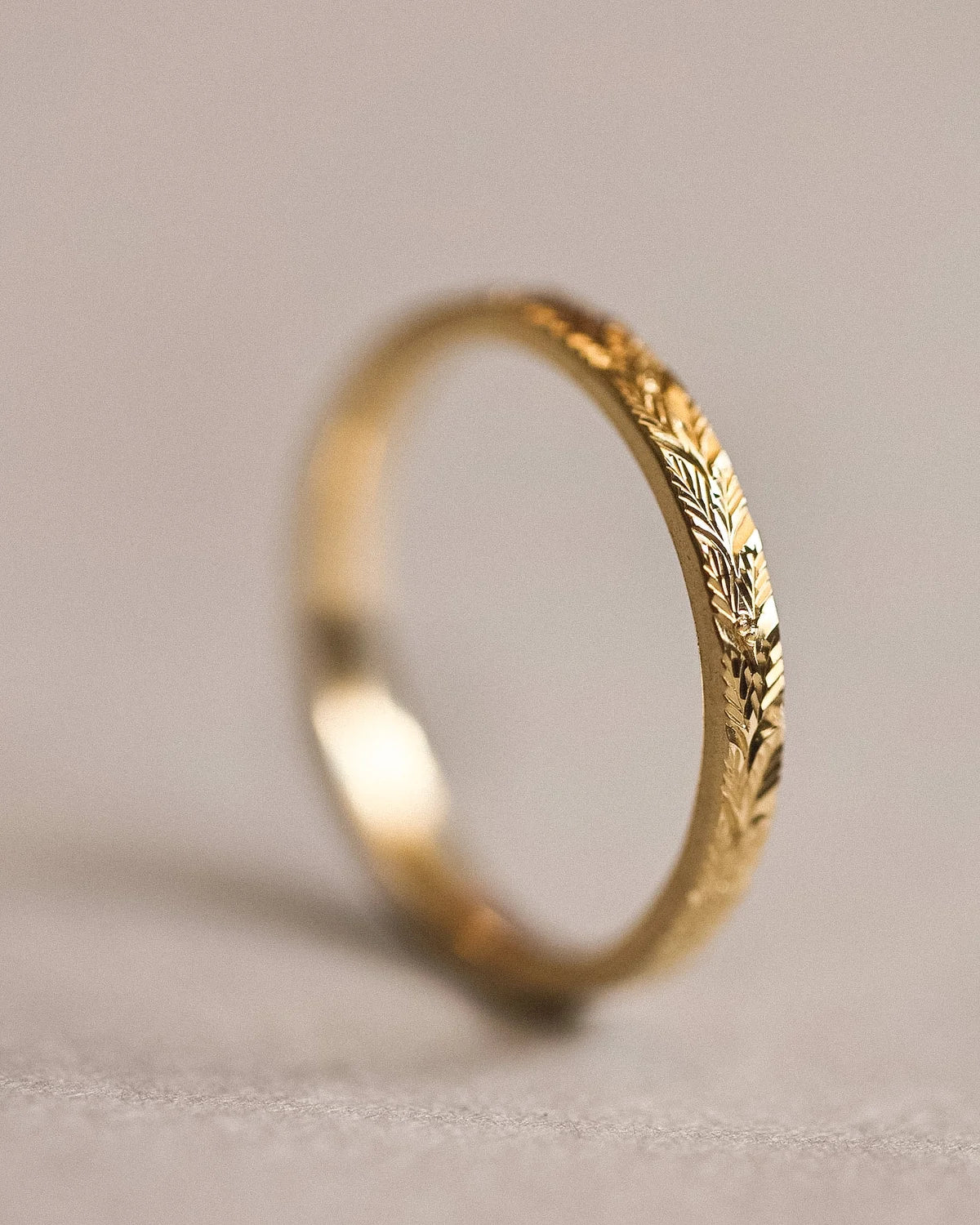 Side view of 18ct yellow gold laurel leaf engraved wedding ring