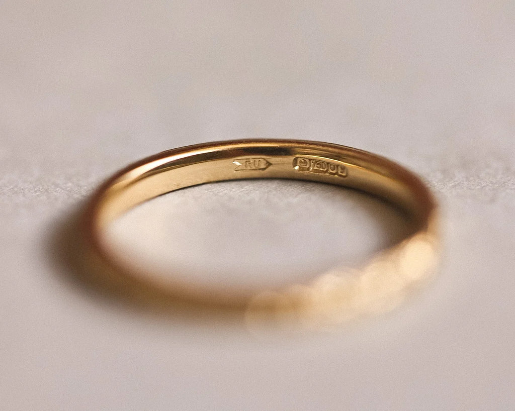 Inside view of 18ct yellow gold flat court wedding ring with hallmark