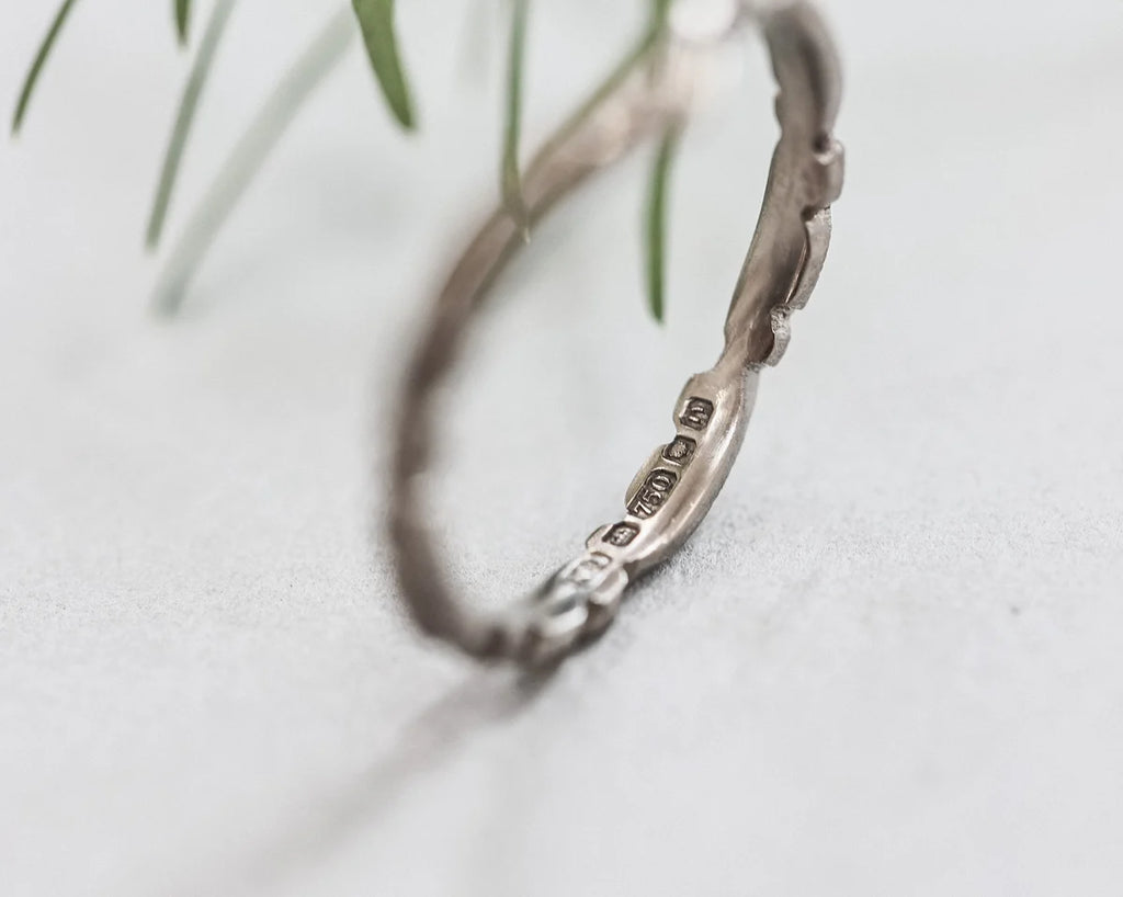 Silver bracelet with engraved details on a light background