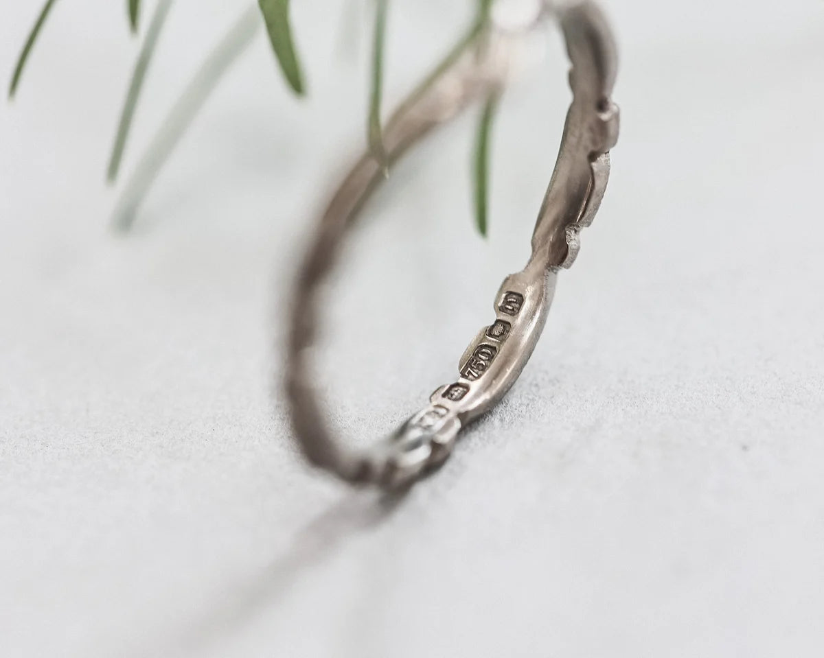 Silver bracelet with engraved details on a light background