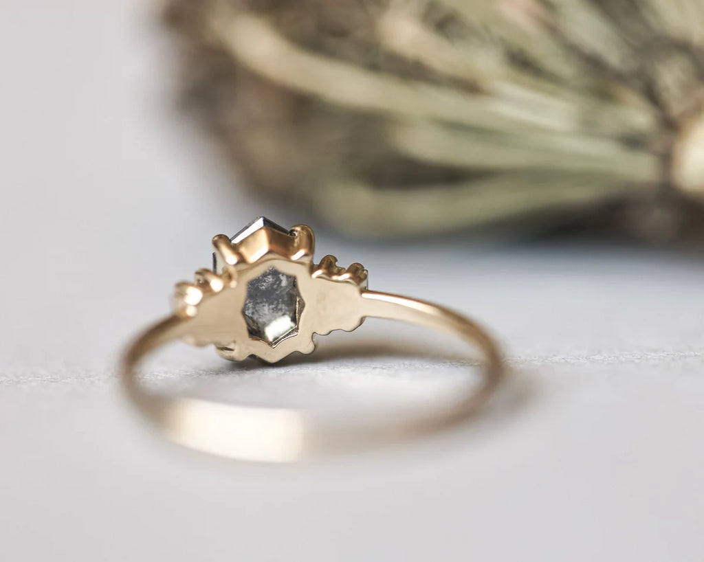 Back view of yellow gold hexagonal diamond ring with plain band