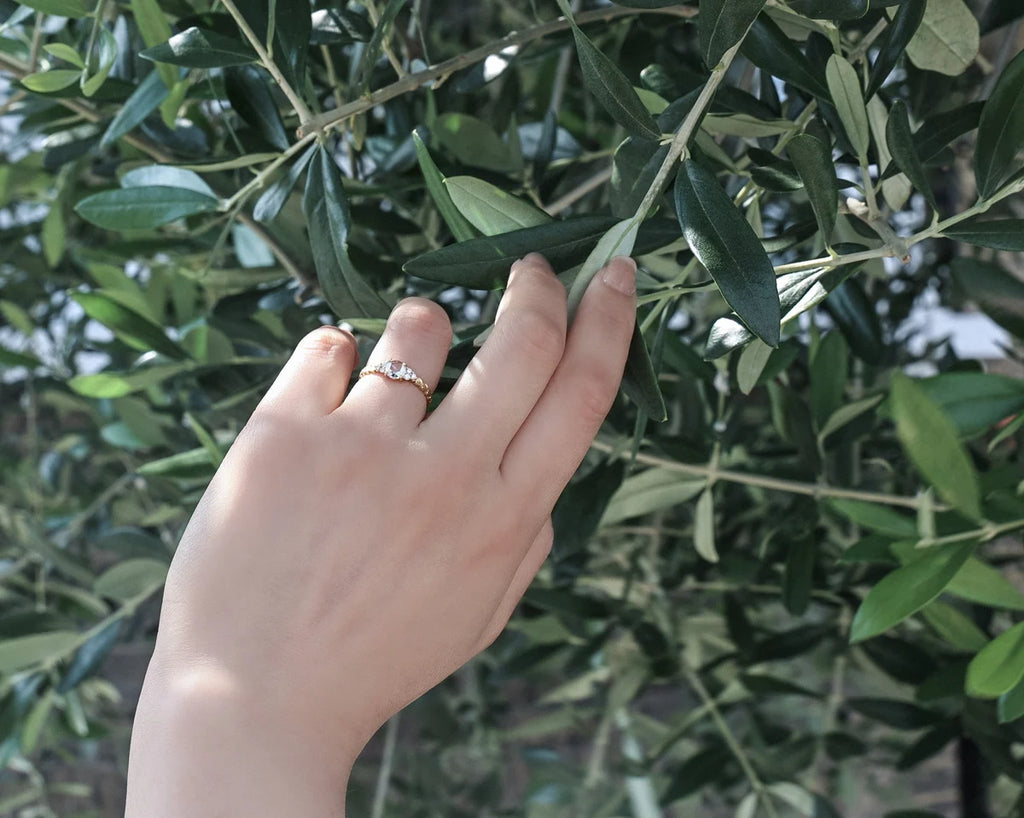 Laurel leaf diamond ring worn on hand with olive tree styling