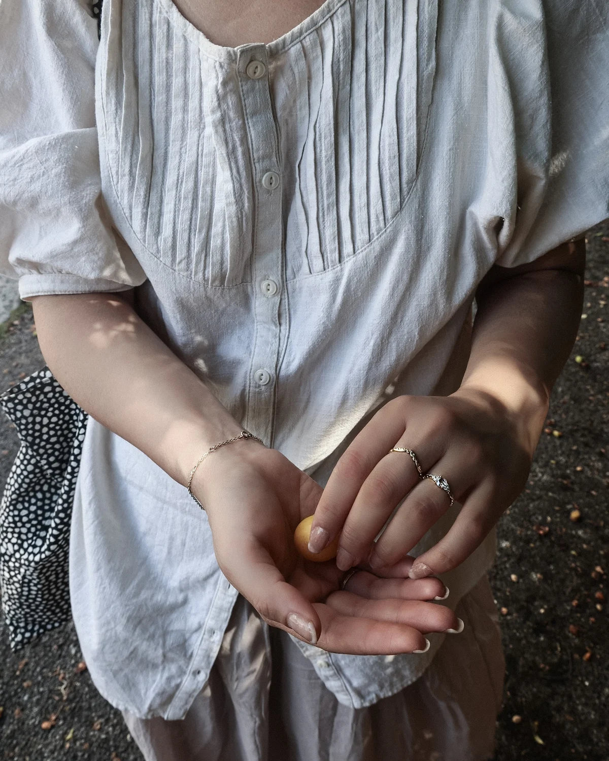 Rose-cut diamond laurel leaf ring worn with linen dress