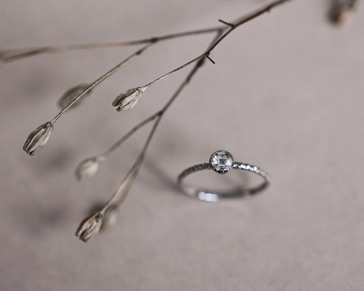 Minimal platinum rose-cut diamond faceted ring with botanical styling