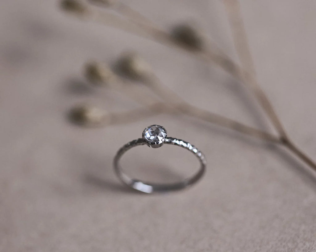 Angled view of 4mm rose-cut diamond ring in platinum