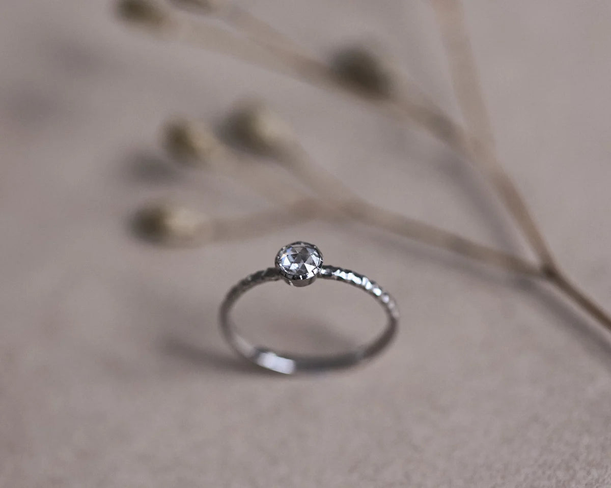 Angled view of 4mm rose-cut diamond ring in platinum