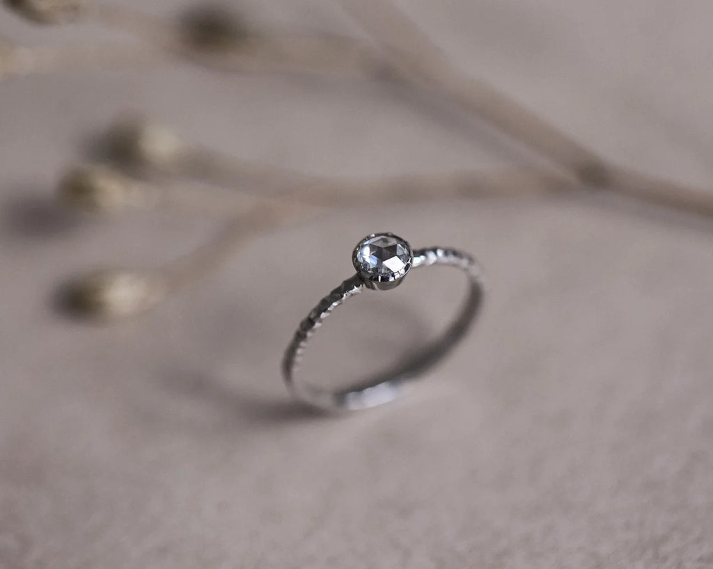 Side view of platinum rose-cut diamond faceted ring