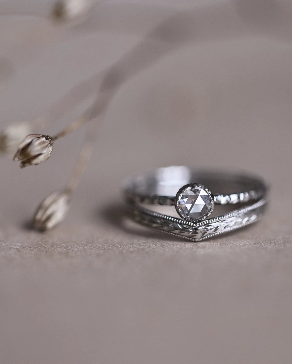 Detailed view of rose-cut diamond and hand carved faceted platinum band