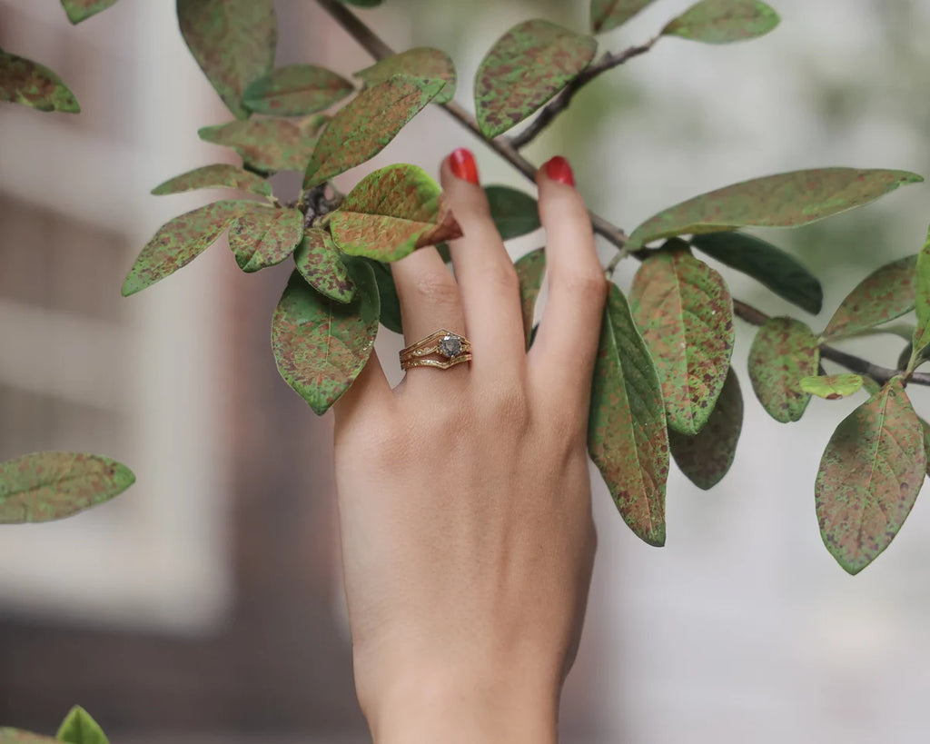 Lifestyle image of grey diamond ring worn with botanical styling