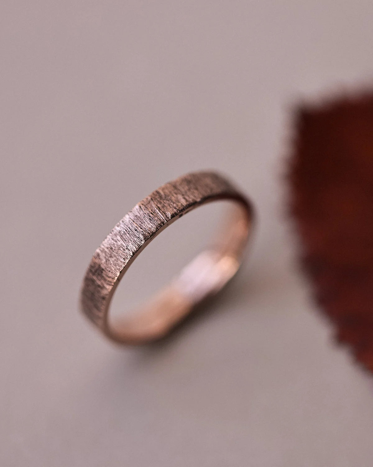 Side view of handmade horn texture flat court ring in rose gold