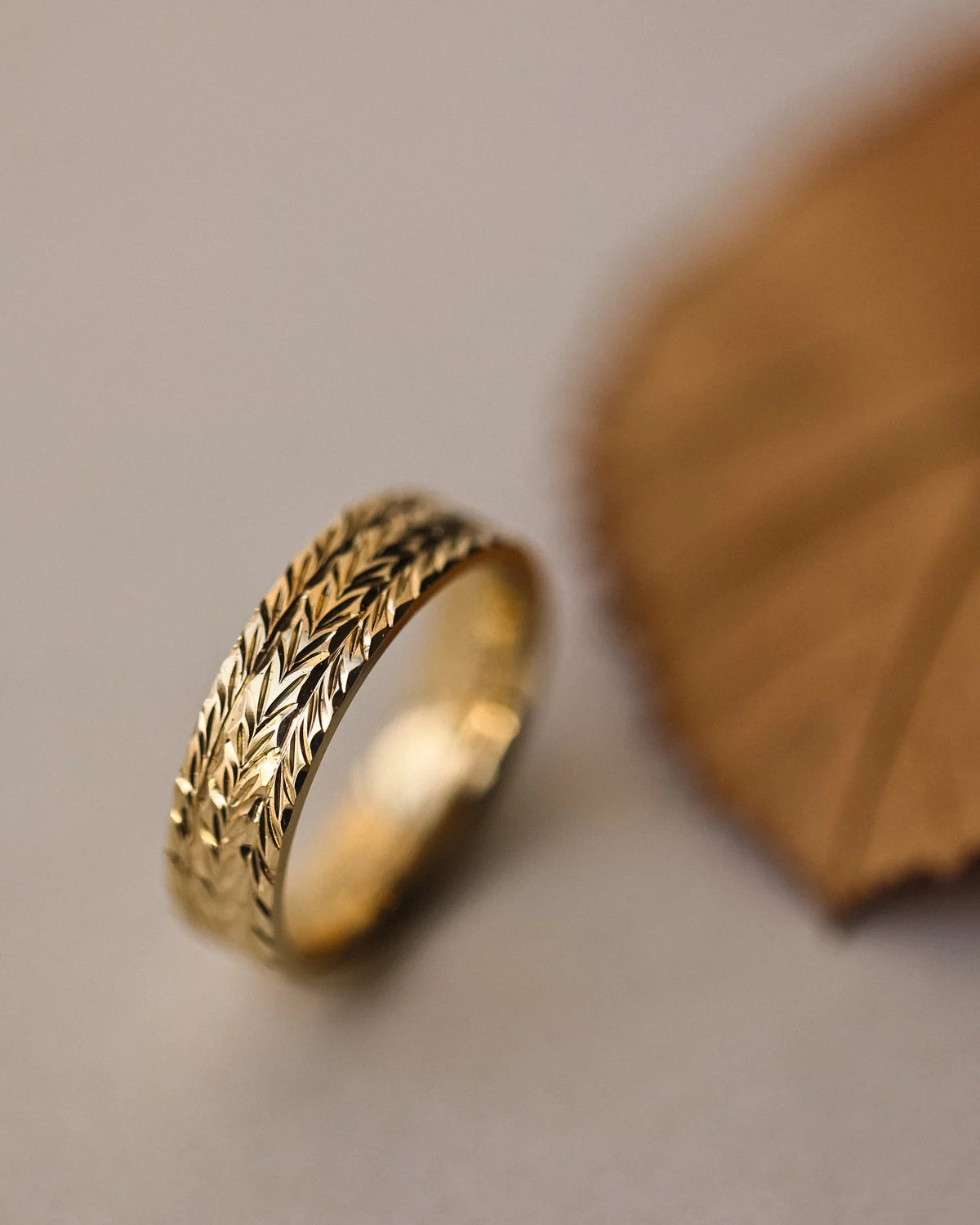 Detailed view of herringbone engraving on 18ct yellow gold band