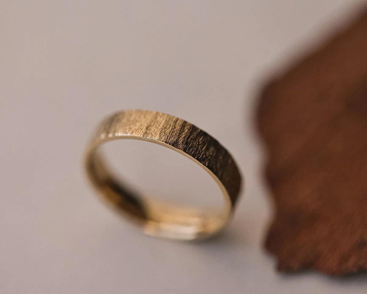 Angled view of handmade horn texture ring in yellow gold