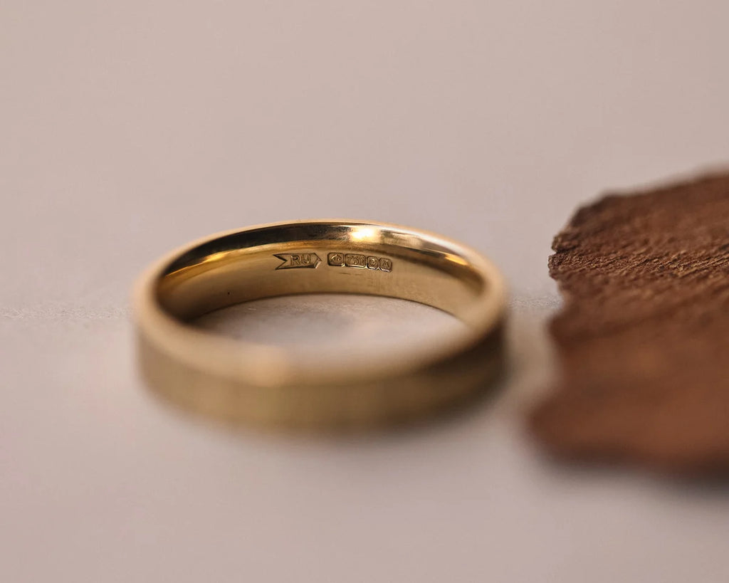 Back view of 18ct yellow gold flat court wedding ring with smooth interior