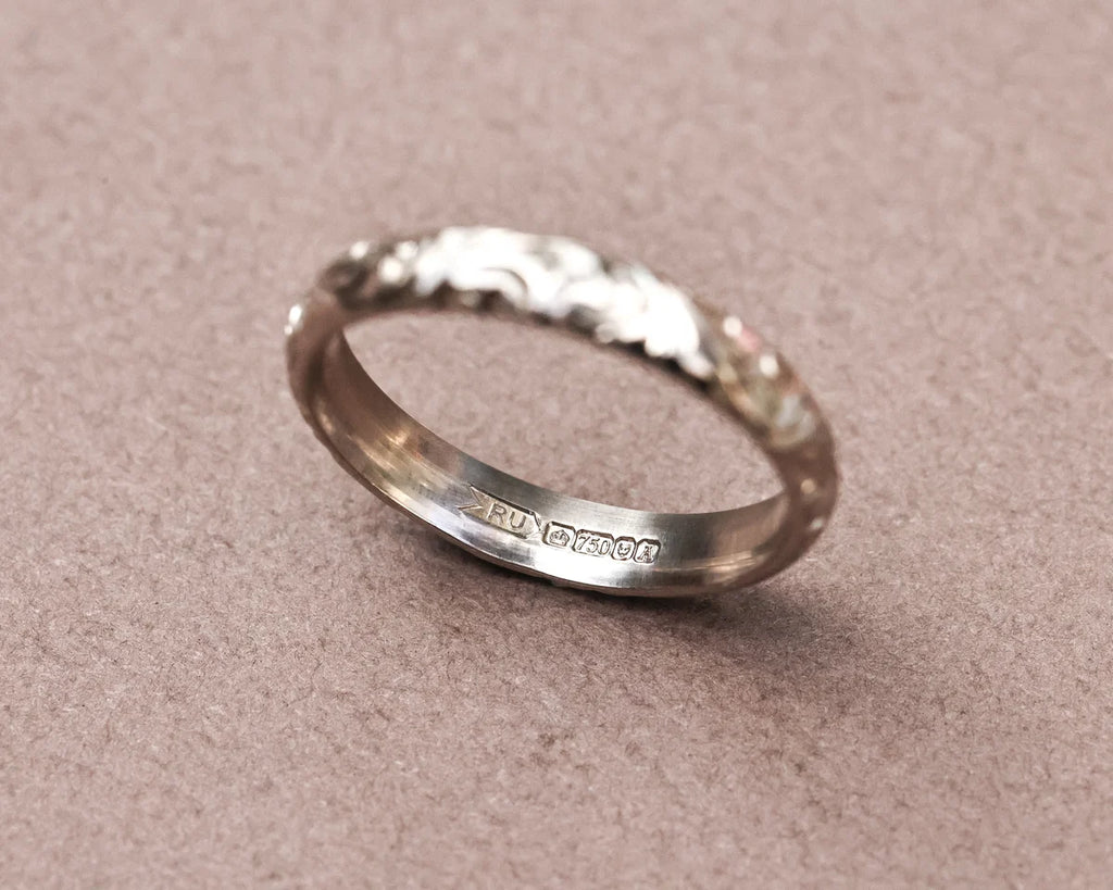 Inside view of 18ct white gold floral engraved ring with hallmark