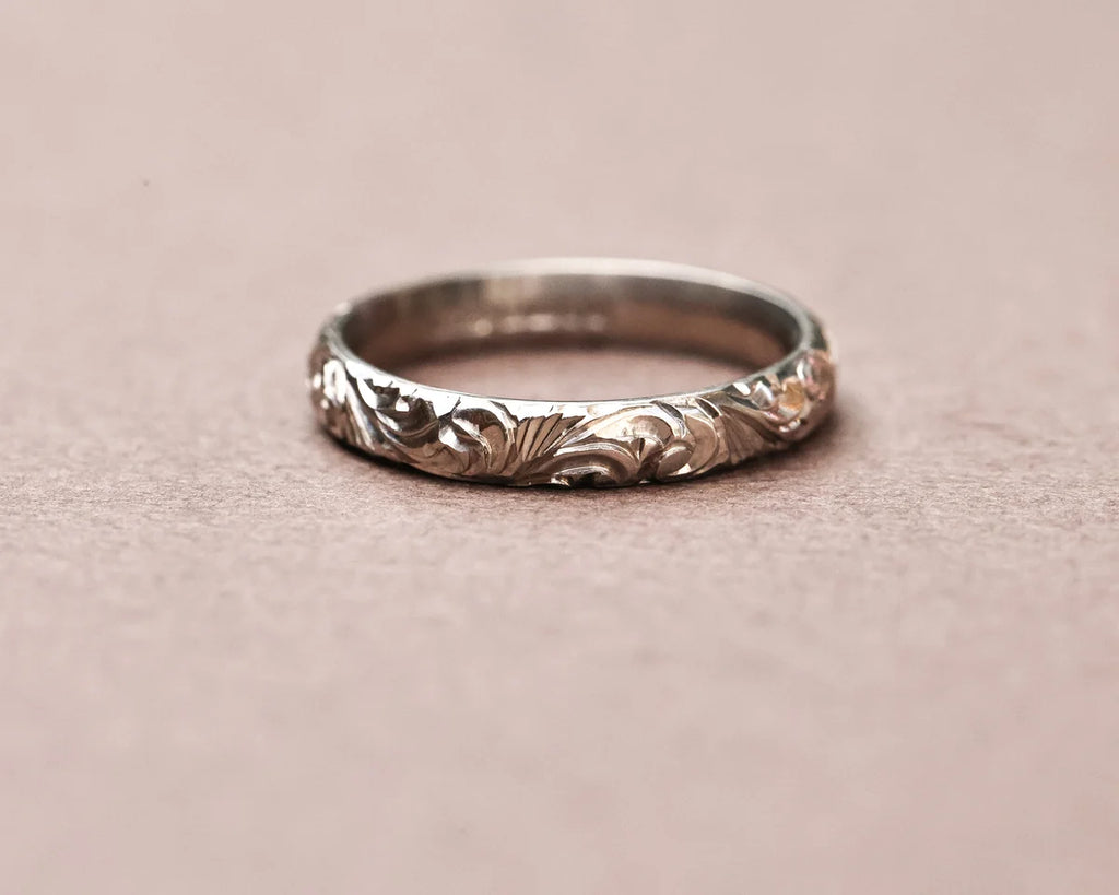 Low front view of handmade floral wedding band in white gold