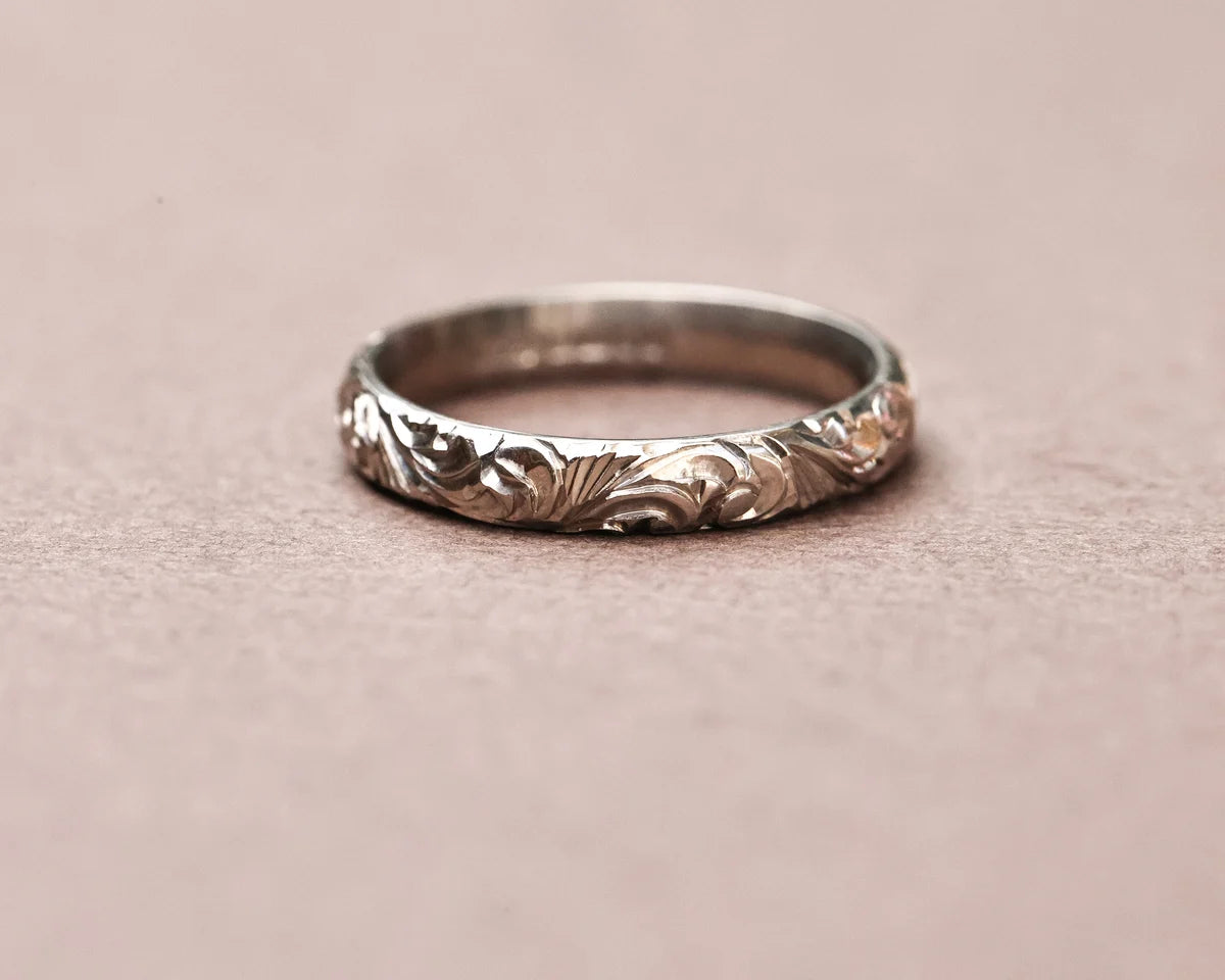 Low front view of handmade floral wedding band in white gold