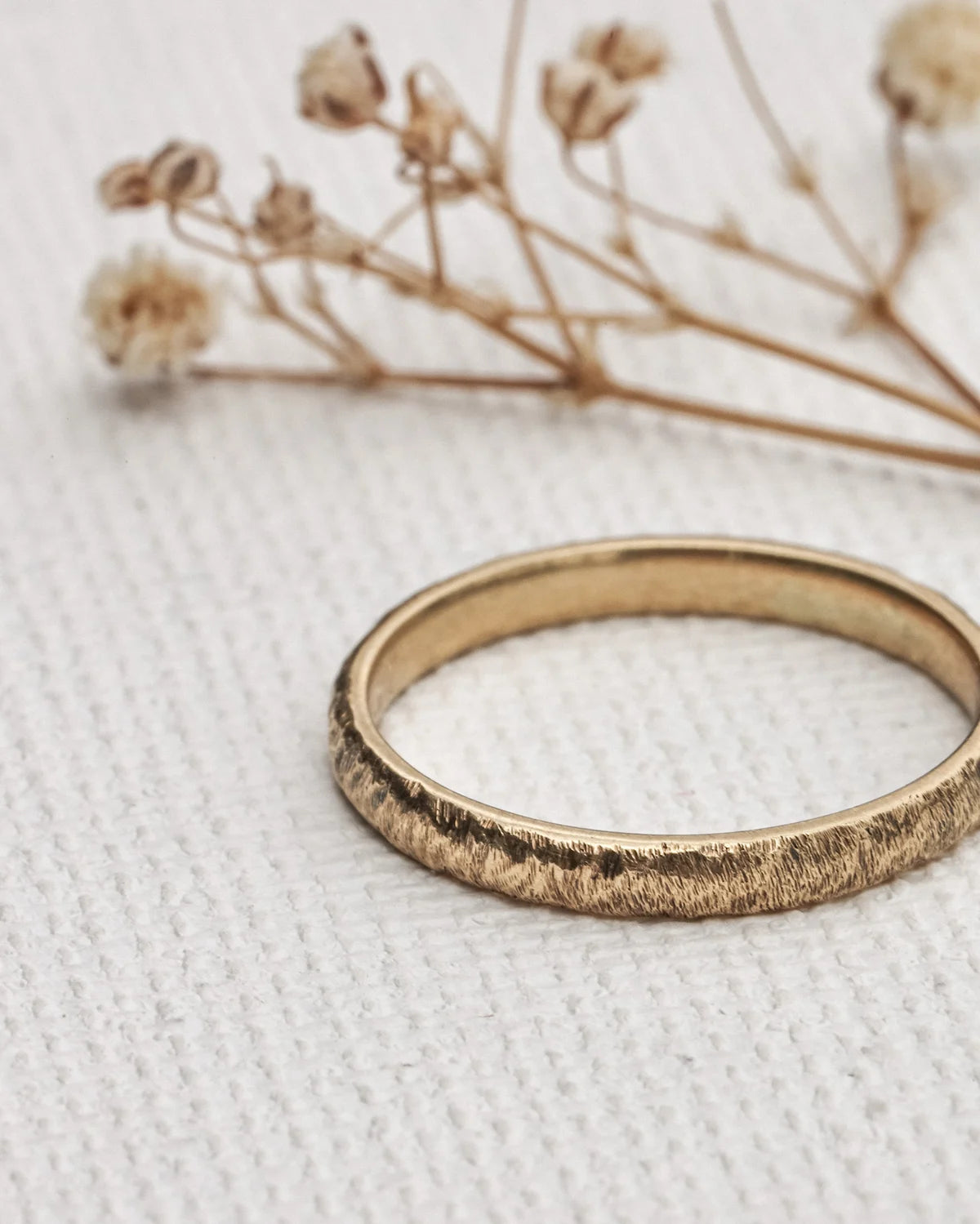 natural texture detail gold wedding band close up