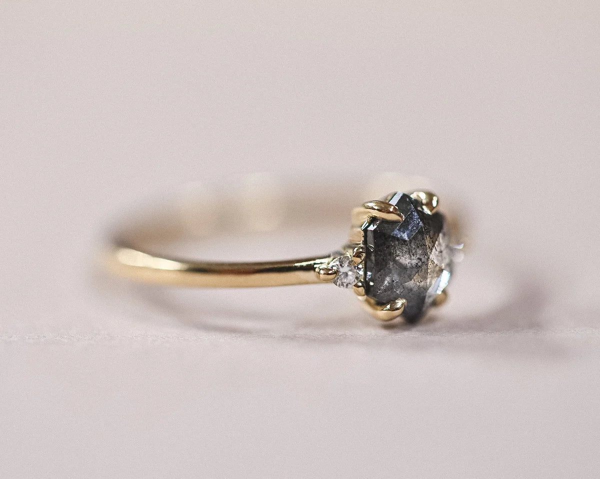 Side profile of grey rose-cut diamond trilogy ring in 18ct yellow gold