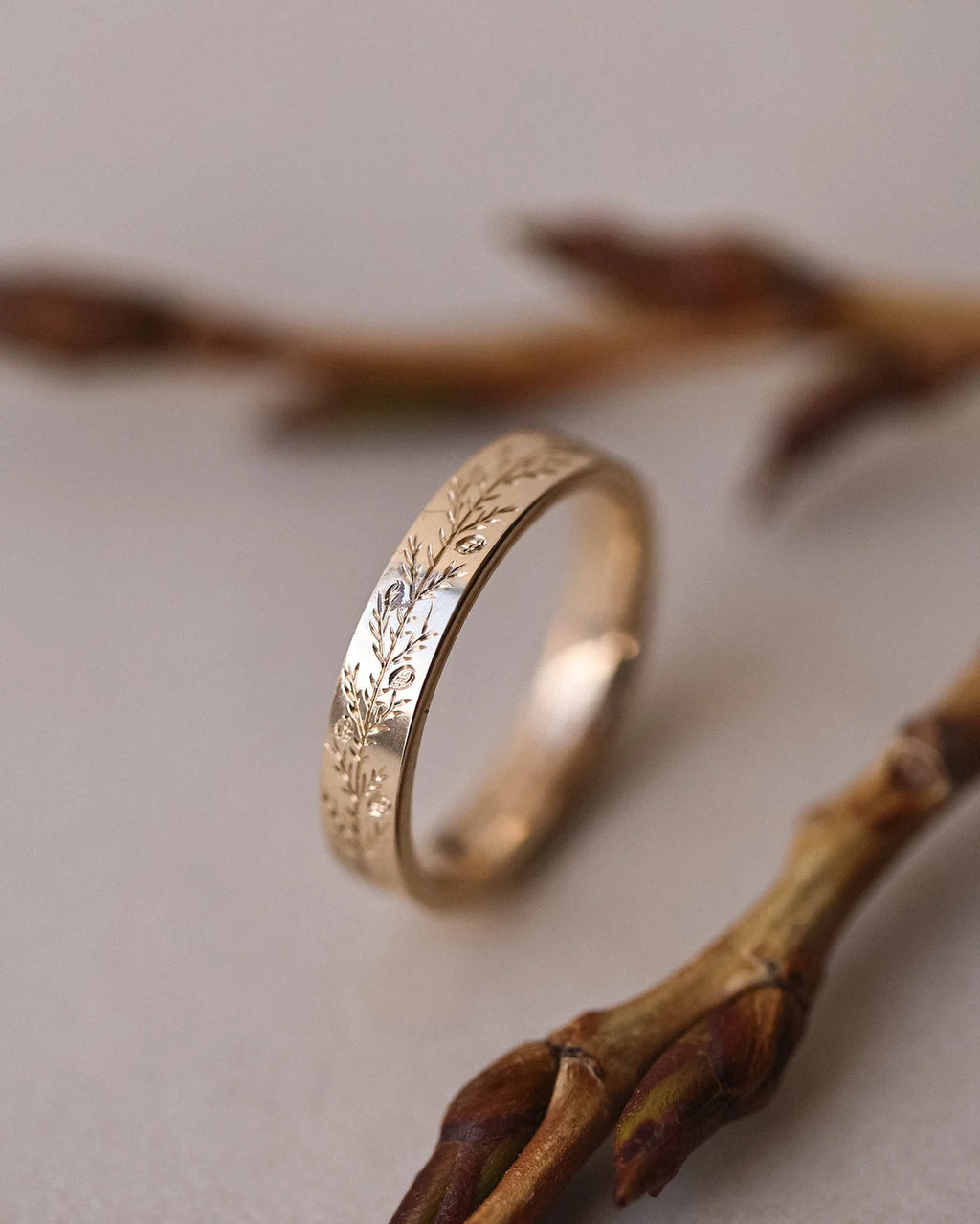 Side view of 9ct yellow gold fir engraved flat court wedding ring