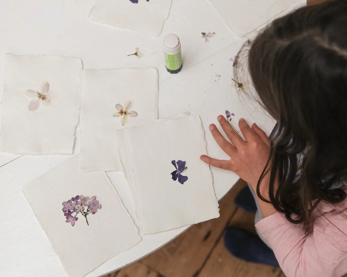 Pressed flower design process image with floral layout
