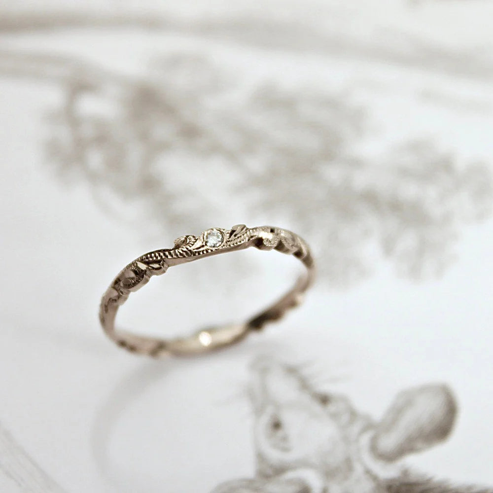 wedding ring with small diamond detail worn on hand