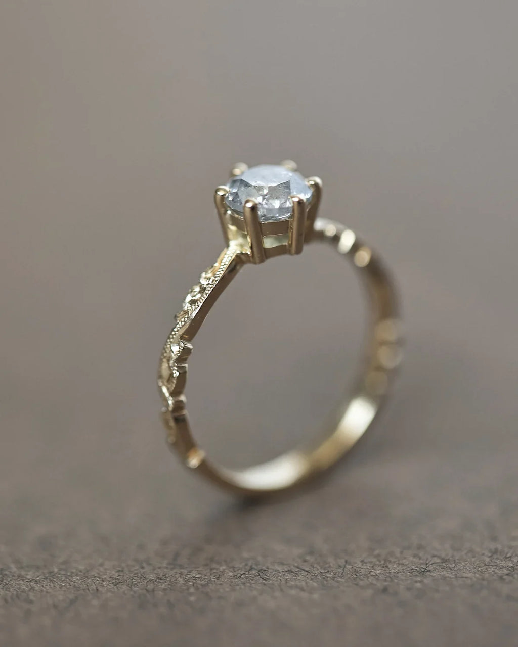 Vertical view of grey salt and pepper diamond ring in 18ct yellow gold