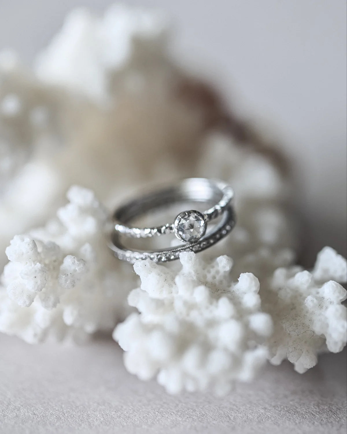 

Platinum rose-cut diamond faceted ring styled with coral
